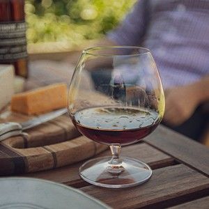 photo of wine glass and cheese board 